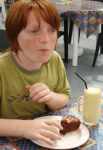 Boy eating cake at café